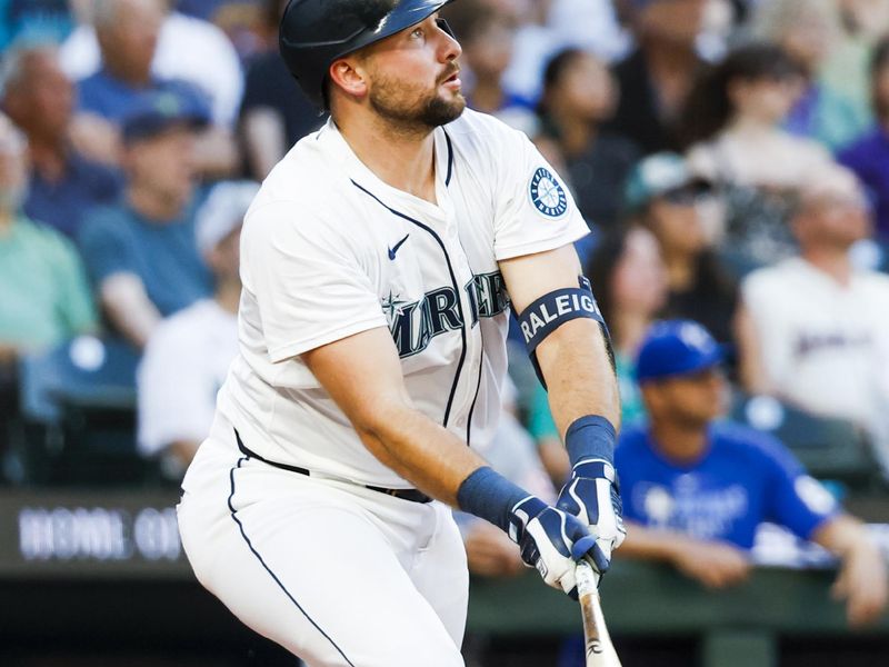 Jun 30, 2025; Seattle, Washington, USA; Seattle Mariners catcher Cal Raleigh (29) hits a solo-home run against the Kansas City Royals during the seventh inning at T-Mobile Park. Mandatory Credit: Joe Nicholson-Imagn Images