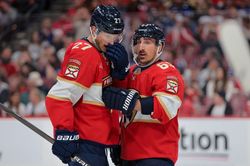 Apr 8, 2025; Sunrise, Florida, USA; Florida Panthers center Brad Marchand (63) and center Eetu Luostarinen (27) talk during the third period against the Toronto Maple Leafs at Amerant Bank Arena. Mandatory Credit: Sam Navarro-Imagn Images