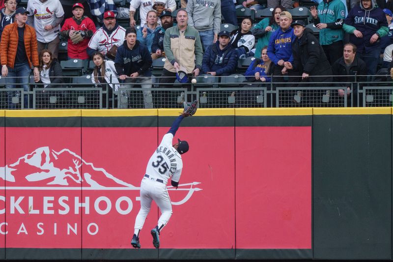 Apr 21, 2023; Seattle, Washington, USA; Seattle Mariners right fielder Teoscar Hernandez (35) is unable to hold on to a ball hit by St. Louis Cardinals right fielder Jordan Walker for a two-run RBI double during the second inning at T-Mobile Park. Mandatory Credit: Stephen Brashear-USA TODAY Sports