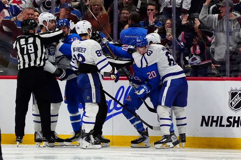Jan 12, 2026; Denver, Colorado, USA; Members of the Toronto Maple Leafs and the Colorado Avalanche fight in the third period at Ball Arena. Mandatory Credit: Ron Chenoy-Imagn Images
