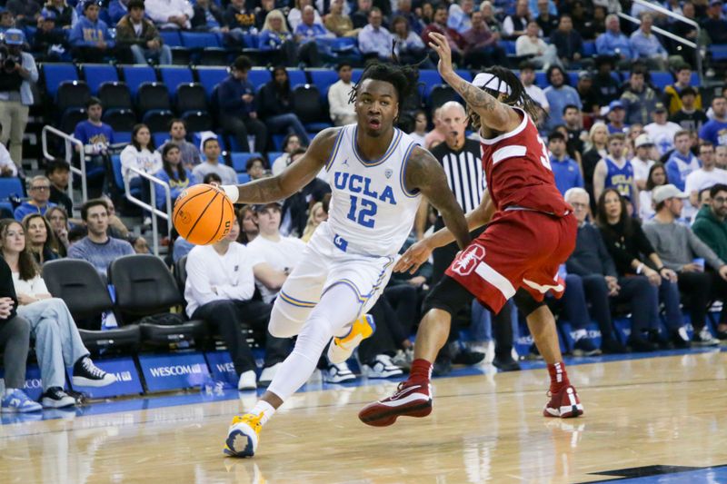 Jan 3, 2024; Los Angeles, California, USA; UCLA guard Sebastian Mack (12) drives the ball as Stanford Cardinal guard Kanaan Carlyle (3) defends during the second half at Pauley Pavilion presented by Wescom. Mandatory Credit: Yannick Peterhans-USA TODAY Sports