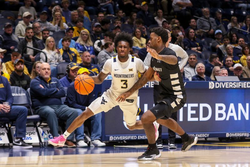 Jan 6, 2026; Morgantown, West Virginia, USA; West Virginia Mountaineers guard Honor Huff (3) dribbles against Cincinnati Bearcats guard Jizzle James (2) during the second half at Hope Coliseum. Mandatory Credit: Ben Queen-Imagn Images