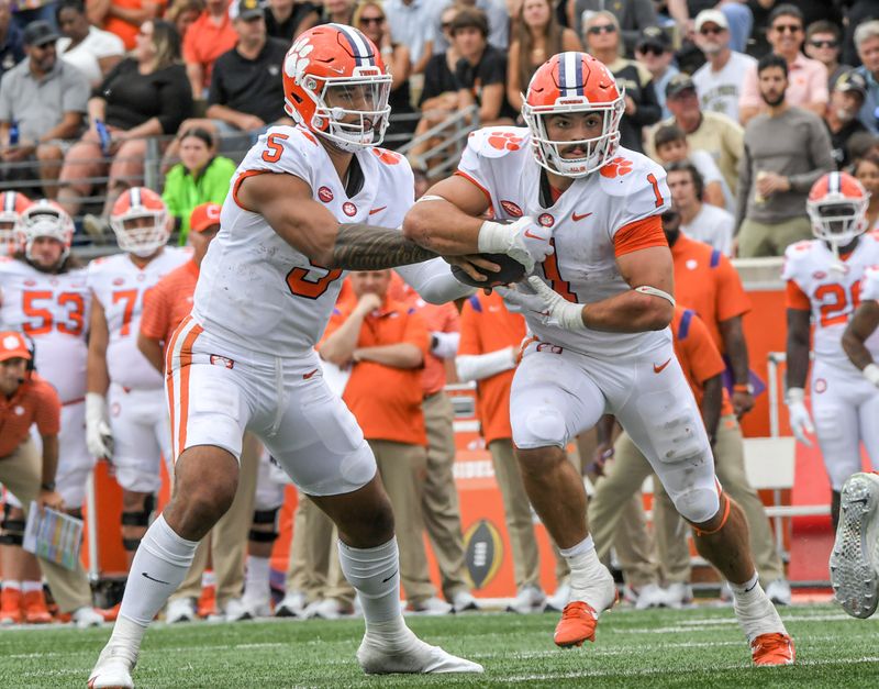 Sep 24, 2022; Winston-Salem, NC, USA; Clemson quarterback D.J. Uiagalelei (5) hands off to running back Will Shipley (1) during the third quarter at Truist Field in Winston-Salem, North Carolina on Saturday, September 24, 2022.   Mandatory Credit: Ken Ruinard-USA TODAY Sports