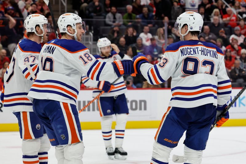 Feb 7, 2023; Detroit, Michigan, USA;  Edmonton Oilers center Ryan Nugent-Hopkins (93) receives congratulations from teammates after scoring in the third period against the Detroit Red Wings at Little Caesars Arena. Mandatory Credit: Rick Osentoski-USA TODAY Sports