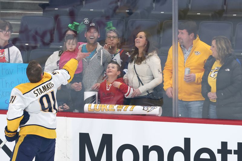 Mar 17, 2026; Winnipeg, Manitoba, CAN; Nashville Predators center Steven Stamkos (91) tosses puck to fans before a game against the Winnipeg Jets at Canada Life Centre. Mandatory Credit: James Carey Lauder-Imagn Images