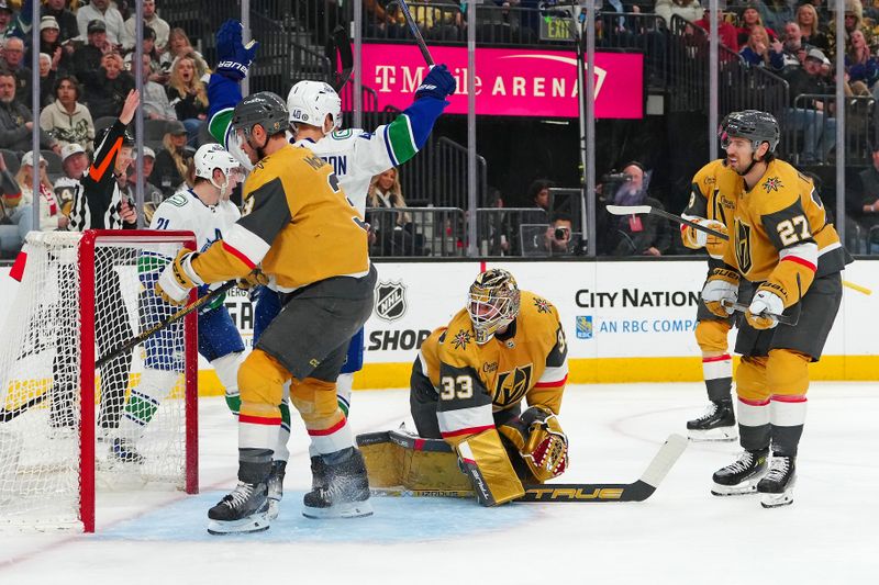 Mar 7, 2024; Las Vegas, Nevada, USA; Vancouver Canucks center Elias Pettersson (40) celebrates a goal scored by Vancouver Canucks left wing Phillip Di Giuseppe (34) against the Vegas Golden Knights during the first period at T-Mobile Arena. Mandatory Credit: Stephen R. Sylvanie-USA TODAY Sports