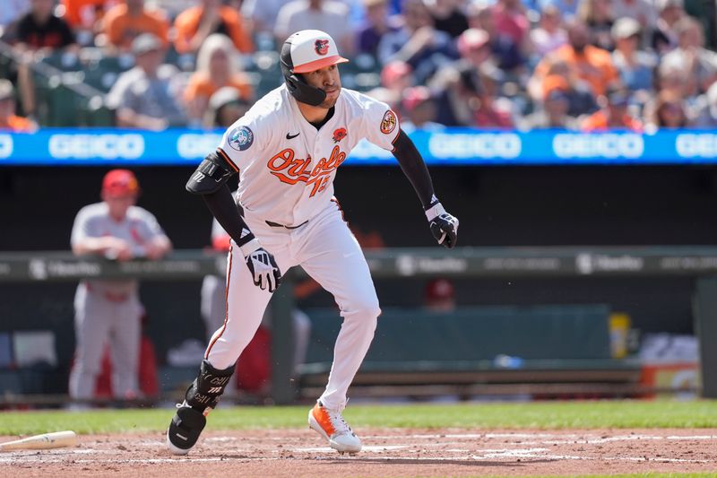 May 26, 2025; Baltimore, Maryland, USA; Baltimore Orioles center fielder Dylan Carlson (15) runs out a single against the St. Louis Cardinals during the third inning at Oriole Park at Camden Yards. Mandatory Credit: Gregory Fisher-Imagn Images