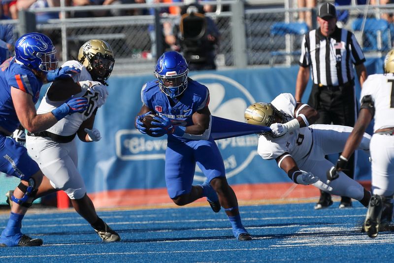 Sep 9, 2023; Boise, Idaho, USA; Boise State Broncos running back Ashton Jeanty (2) runs out of the grasp of UCF Knights linebacker Jason Johnson (0) during the first half of action versus the UCF Knights at Albertsons Stadium. Mandatory Credit: Brian Losness-USA TODAY Sports

