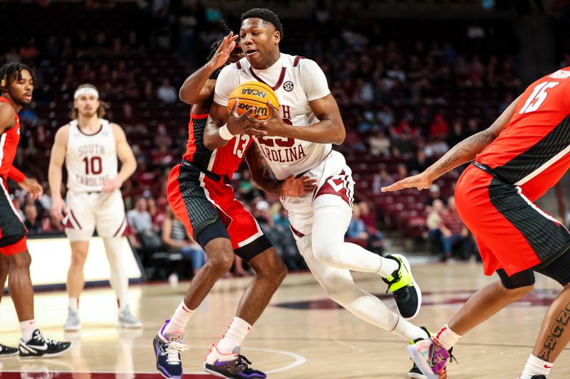 Mar 4, 2023; Columbia, South Carolina, USA; South Carolina Gamecocks forward Gregory Jackson II (23) drives around Georgia Bulldogs guard Mardrez McBride (13) in the first half at Colonial Life Arena. Mandatory Credit: Jeff Blake-USA TODAY Sports