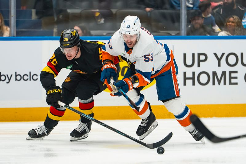 Jan 19, 2026; Vancouver, British Columbia, CAN; Vancouver Canucks defenseman Elias Pettersson (25) defends against New York Islanders forward Casey Cizikas (53) in the first period at Rogers Arena. Mandatory Credit: Bob Frid-Imagn Images