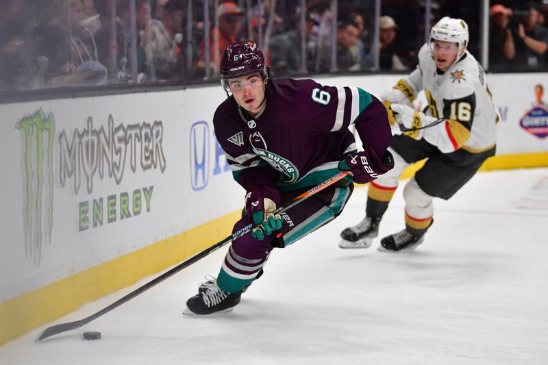 Dec 27, 2023; Anaheim, California, USA; Anaheim Ducks defenseman Jamie Drysdale (6) moves the puck ahead of Vegas Golden Knights left wing Pavel Dorofeyev (16) during the second period at Honda Center. Mandatory Credit: Gary A. Vasquez-USA TODAY Sports