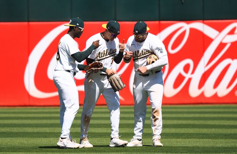 May 25, 2024; Oakland, California, USA; Oakland Athletics outfielders celebrate after the game against the Houston Astros at Oakland-Alameda County Coliseum. Mandatory Credit: Kelley L Cox-USA TODAY Sports