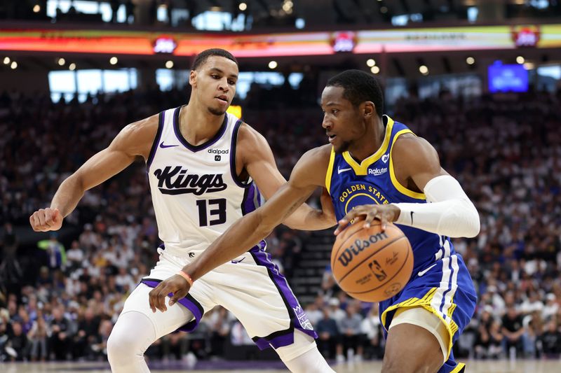 SACRAMENTO, CALIFORNIA - APRIL 16: Jonathan Kuminga #00 of the Golden State Warriors is guarded by Keegan Murray #13 of the Sacramento Kings in the first quarter during the Play-In Tournament at Golden 1 Center on April 16, 2024 in Sacramento, California.  NOTE TO USER: User expressly acknowledges and agrees that, by downloading and or using this photograph, User is consenting to the terms and conditions of the Getty Images License Agreement.  (Photo by Ezra Shaw/Getty Images)