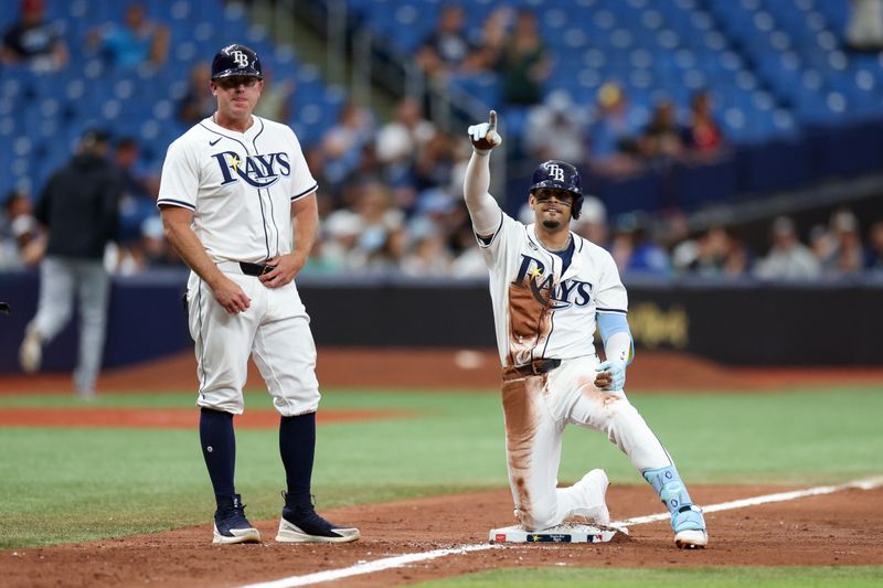 Sep 5, 2024; St. Petersburg, Florida, USA; Tampa Bay Rays second baseman Christopher Morel (24) triples against the Minnesota Twins in the eighth inning at Tropicana Field. Mandatory Credit: Nathan Ray Seebeck-Imagn Images