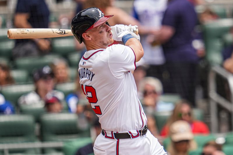 Jun 19, 2024; Cumberland, Georgia, USA; Atlanta Braves catcher Sean Murphy (12) hits a home run against the Detroit Tigers during the third inning at Truist Park. Mandatory Credit: Dale Zanine-USA TODAY Sports