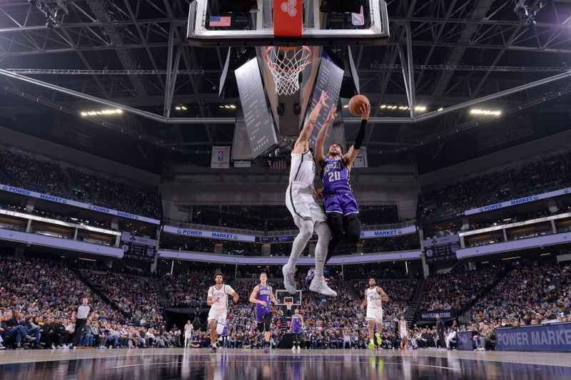 SACRAMENTO, CA - NOVEMBER 24: Colby Jones #20 of the Sacramento Kings drives to the basket during the game against the Brooklyn Nets on November 24, 2024 at Golden 1 Center in Sacramento, California. NOTE TO USER: User expressly acknowledges and agrees that, by downloading and or using this Photograph, user is consenting to the terms and conditions of the Getty Images License Agreement. Mandatory Copyright Notice: Copyright 2024 NBAE (Photo by Rocky Widner/NBAE via Getty Images)