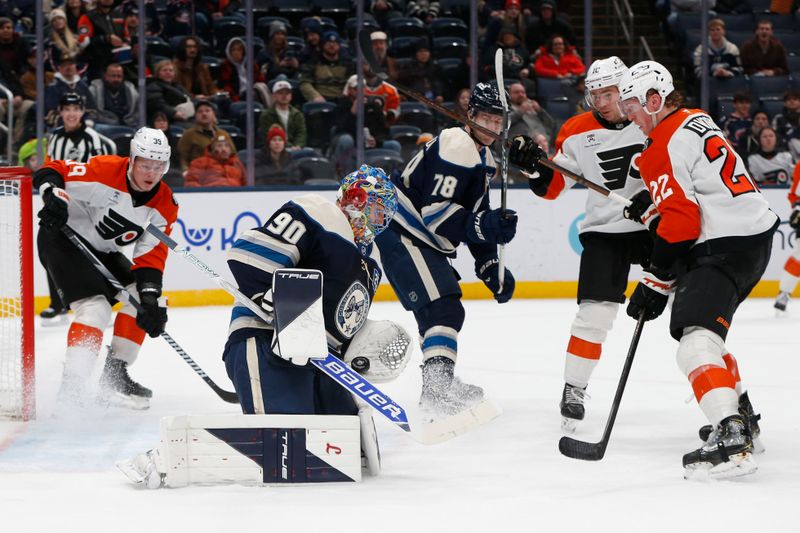 Jan 28, 2026; Columbus, Ohio, USA; Columbus Blue Jackets goalie Elvis Merzlikins (90) makes a save as Philadelphia Flyers center Christian Dvorak (22) looks for a rebound during the third period at Nationwide Arena. Mandatory Credit: Russell LaBounty-Imagn Images