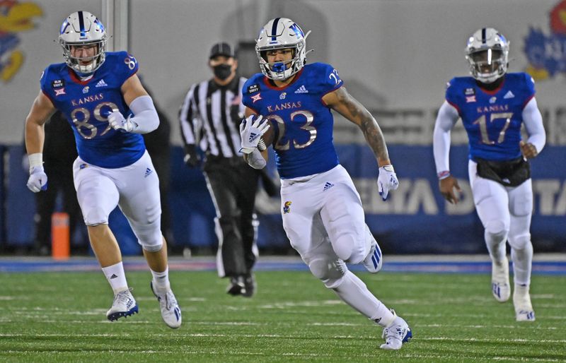 Nov 28, 2020; Lawrence, Kansas, USA; Running back Amauri Pesek-Hickson (23) runs up field for a first down during the second quarter against the TCU Horned Frogs at David Booth Kansas Memorial Stadium. Mandatory Credit: Peter Aiken-USA TODAY Sports