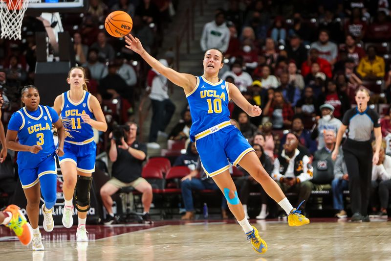 Nov 29, 2022; Columbia, South Carolina, USA; UCLA Bruins guard Gina Conti (10) makes a long shot attempt at the end of the third quarter against the South Carolina Gamecocks in the second half at Colonial Life Arena. Mandatory Credit: Jeff Blake-USA TODAY Sports