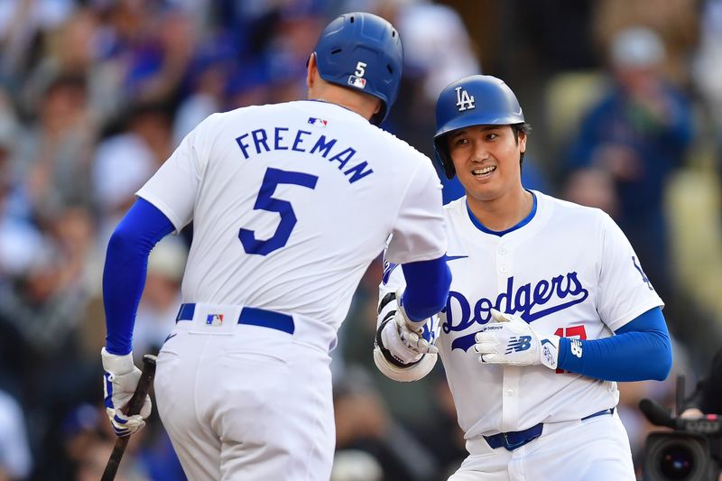 May 4, 2024; Los Angeles, California, USA; Los Angeles Dodgers designated hitter Shohei Ohtani (17) is greeted by first baseman Freddie Freeman (5) after hitting a solo home run against the Atlanta Braves during the third inning at Dodger Stadium. Mandatory Credit: Gary A. Vasquez-USA TODAY Sports