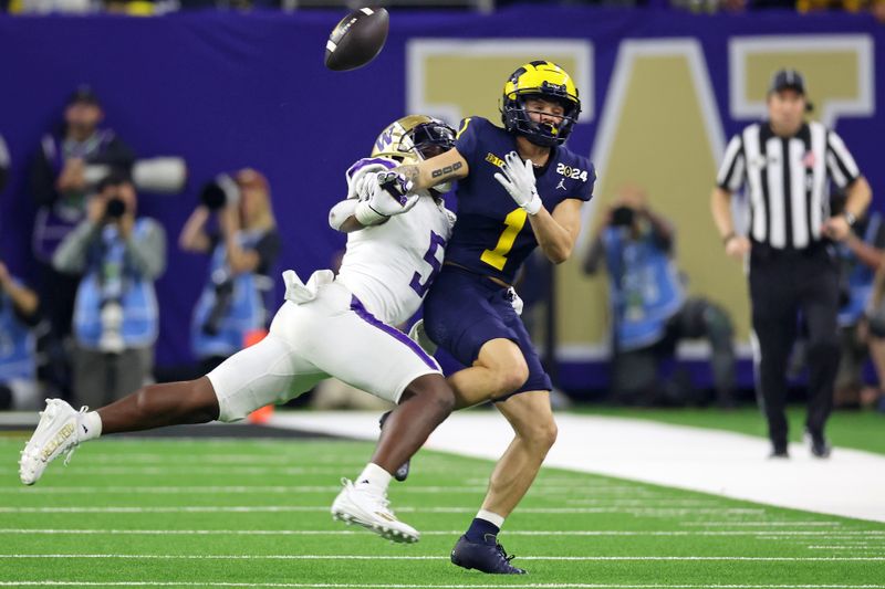 Jan 8, 2024; Houston, TX, USA; Washington Huskies linebacker Edefuan Ulofoshio (5) breaks up a pass intended for Michigan Wolverines wide receiver Roman Wilson (1) during the second quarter in the 2024 College Football Playoff national championship game at NRG Stadium. Mandatory Credit: Thomas Shea-USA TODAY Sports