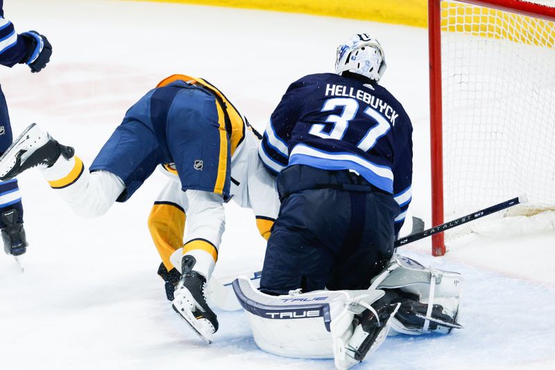 Mar 13, 2024; Winnipeg, Manitoba, CAN; Nashville Predators forward Keifer Sherwood (44) collides with Winnipeg Jets goalie Connor Hellebuyck (37) during the third period at Canada Life Centre. Mandatory Credit: Terrence Lee-USA TODAY Sports