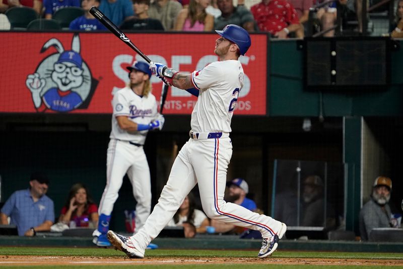 Aug 31, 2024; Arlington, Texas, USA; Texas Rangers catcher Jonah Heim (28) hits a two-run home run during the second inning against the Oakland Athletics at Globe Life Field. Mandatory Credit: Raymond Carlin III-USA TODAY Sports