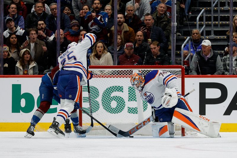 Jan 16, 2025; Denver, Colorado, USA; Colorado Avalanche center Casey Mittelstadt (37) attempts to knock in the puck against Edmonton Oilers goaltender Stuart Skinner (74) as defenseman Darnell Nurse (25) defends in the first period at Ball Arena. Mandatory Credit: Isaiah J. Downing-Imagn Images