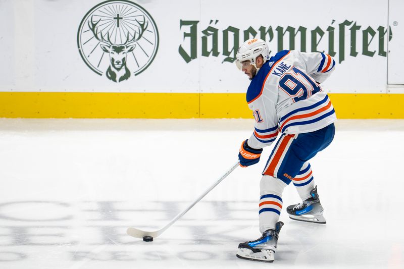 Dec 28, 2023; San Jose, California, USA; Edmonton Oilers left wing Evander Kane (91) skates with the puck against the San Jose Sharks during the third period at SAP Center at San Jose. Mandatory Credit: Neville E. Guard-USA TODAY Sports