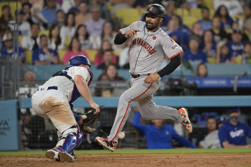 Jul 24, 2024; Los Angeles, California, USA;  Los Angeles Dodgers catcher Will Smith (16) misses the tag on San Francisco Giants first baseman LaMonte Wade Jr. (31) as he scores a run in the eighth inning at Dodger Stadium. Mandatory Credit: Jayne Kamin-Oncea-USA TODAY Sports