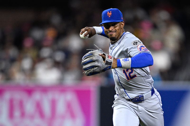 Aug 22, 2024; San Diego, California, USA; New York Mets shortstop Francisco Lindor (12) throws to first base during the sixth inning against the San Diego Padres at Petco Park. Mandatory Credit: Orlando Ramirez-USA TODAY Sports