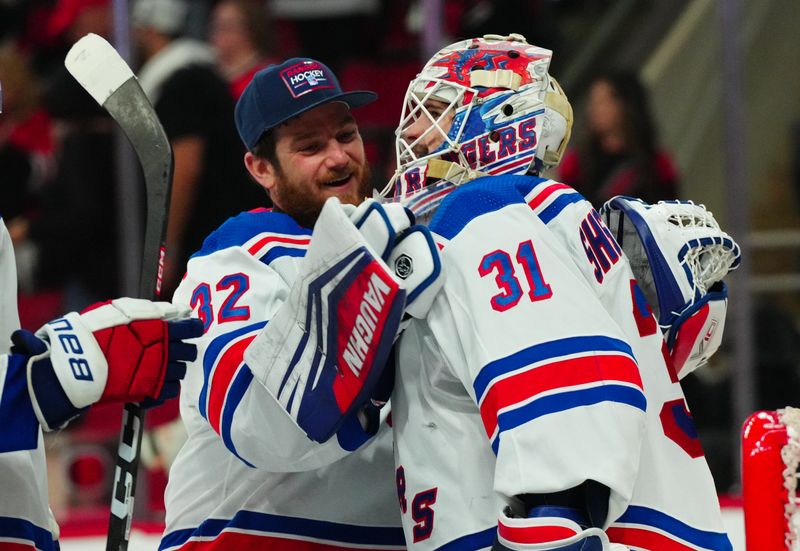 May 16, 2024; Raleigh, North Carolina, USA; New York Rangers goaltender Igor Shesterkin (31) and goaltender Jonathan Quick (32) celebrate their victory against the Carolina Hurricanes in game six of the second round of the 2024 Stanley Cup Playoffs at PNC Arena. Mandatory Credit: James Guillory-USA TODAY Sports