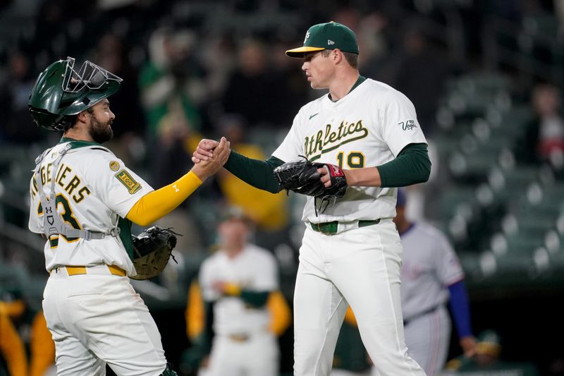 Apr 23, 2025; West Sacramento, California, USA; Athletics pitcher Mason Miller (19) meets with catcher Shea Langeliers (23) after the Athletics defeated the Texas Rangers at Sutter Health Park. Mandatory Credit: Cary Edmondson-Imagn Images
