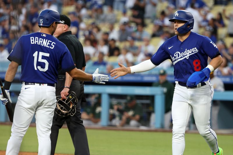 Aug 3, 2023; Los Angeles, California, USA; Los Angeles Dodgers center fielder Enrique Hernandez (8) is greeted by catcher Austin Barnes (15) after scoring a run during the second inning against the Oakland Athletics at Dodger Stadium. Mandatory Credit: Kiyoshi Mio-USA TODAY Sports