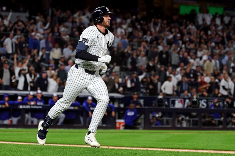 Oct 8, 2025; Bronx, New York, USA; New York Yankees third baseman Ryan McMahon (19) hits a solo home run during the third inning against the Toronto Blue Jays during game four of the ALDS round for the 2025 MLB playoffs at Yankee Stadium. Mandatory Credit: Vincent Carchietta-Imagn Images