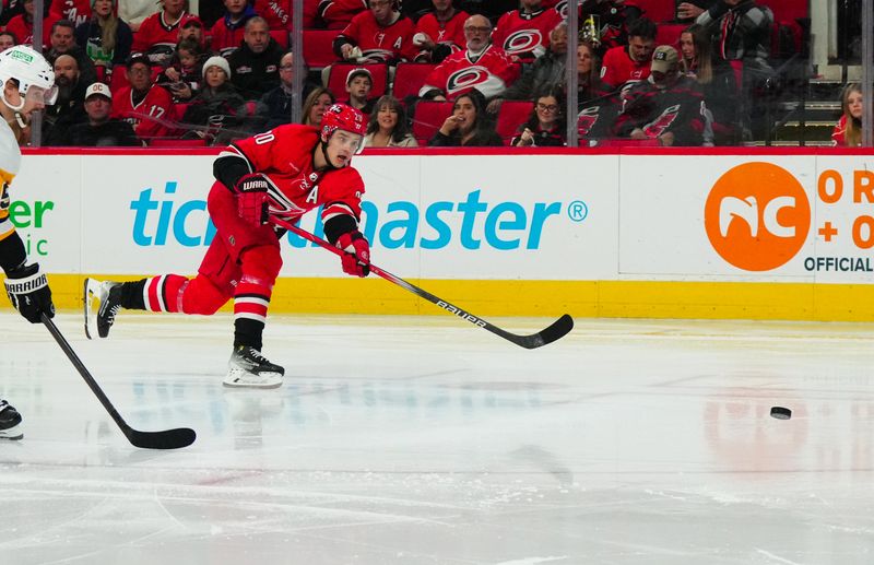 Jan 13, 2024; Raleigh, North Carolina, USA;  Carolina Hurricanes center Sebastian Aho (20) takes a shot against the Pittsburgh Penguins during the third period at PNC Arena. Mandatory Credit: James Guillory-USA TODAY Sports