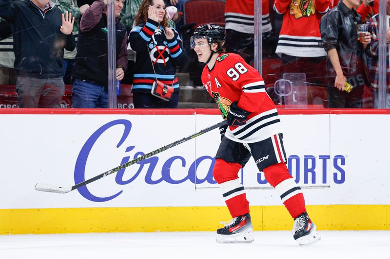Nov 18, 2025; Chicago, Illinois, USA; Chicago Blackhawks center Connor Bedard (98) celebrates after scoring against the Calgary Flames during the second period at United Center. Mandatory Credit: Kamil Krzaczynski-Imagn Images