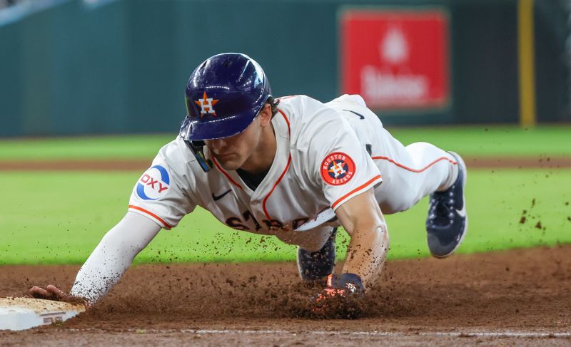 Jun 23, 2024; Houston, Texas, USA; Houston Astros right fielder Joey Loperfido (10) dives back to first against the Baltimore Orioles in the fifth inning at Minute Maid Park. Mandatory Credit: Thomas Shea-USA TODAY Sports