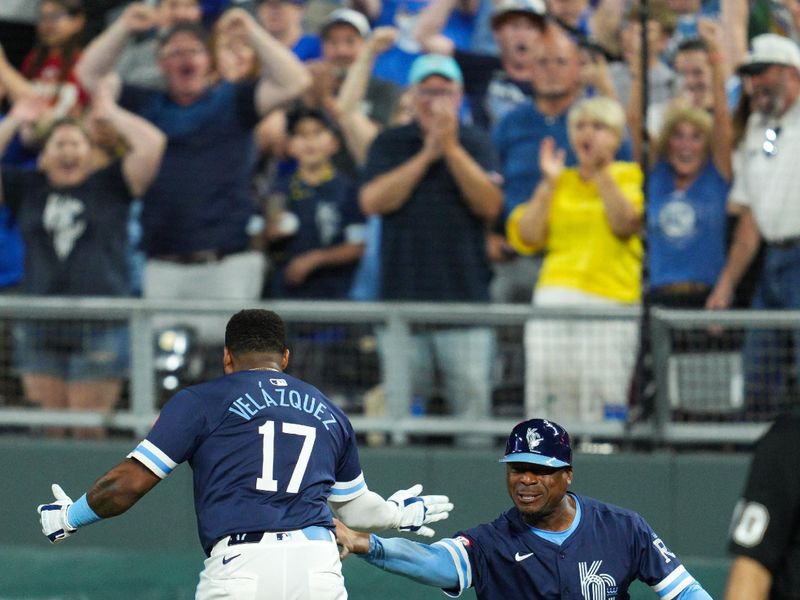 Jun 7, 2024; Kansas City, Missouri, USA; Kansas City Royals designated hitter Nelson Velazquez (17) celebrates with first base coach Damon Hollins (39) after hitting into a fielder’s choice to defeat the Seattle Mariners at Kauffman Stadium. Mandatory Credit: Jay Biggerstaff-USA TODAY Sports