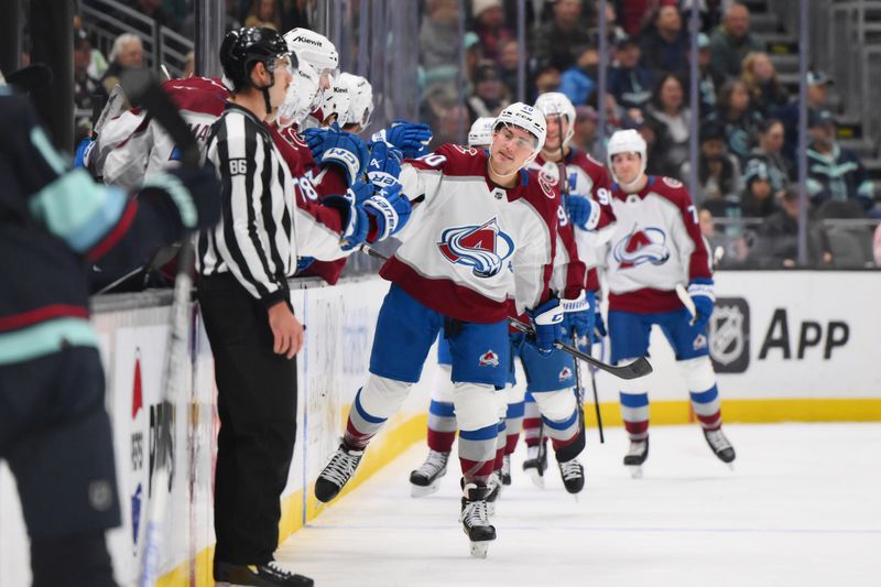 Nov 13, 2023; Seattle, Washington, USA; Colorado Avalanche center Ross Colton (20) celebrates with teammates after scoring a goal against the Seattle Kraken during the second period at Climate Pledge Arena. Mandatory Credit: Steven Bisig-USA TODAY Sports