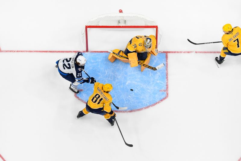 Nov 23, 2024; Nashville, Tennessee, USA;  Nashville Predators goaltender Juuse Saros (74) blocks the shot of Winnipeg Jets center Mason Appleton (22) during the third period at Bridgestone Arena. Mandatory Credit: Steve Roberts-Imagn Images