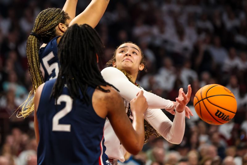 Feb 11, 2024; Columbia, South Carolina, USA; South Carolina Gamecocks guard Tessa Johnson (5) loses the ball as UConn Huskies forward Ice Brady (25) defends in the first half at Colonial Life Arena. Mandatory Credit: Jeff Blake-USA TODAY Sports