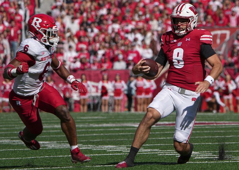 Oct 7, 2023; Madison, Wisconsin, USA; Wisconsin quarterback Tanner Mordecai (8) runs for a first down during the second quarter of their game against Rutgers at Camp Randall Stadium. Mandatory Credit: Mark Hoffman-USA TODAY Sports