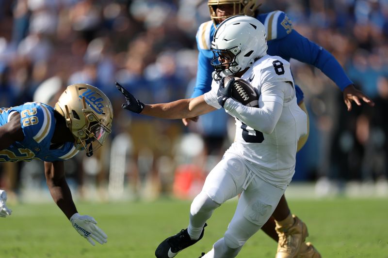 Oct 4, 2025; Pasadena, California, USA;  Penn State Nittany Lions wide receiver Trebor Pena (8) blocks UCLA Bruins defensive back Scooter Jackson (28)  from tackling him during the fourth quarter at Rose Bowl. Mandatory Credit: Kiyoshi Mio-Imagn Images