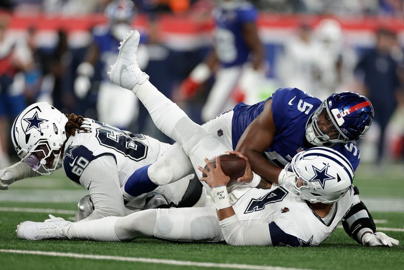 New York Giants linebacker Kayvon Thibodeaux (5) sacks Dallas Cowboys quarterback Dak Prescott (4) during the second quarter of an NFL football game, Thursday, Sept. 26, 2024, in East Rutherford, N.J. (AP Photo/Adam Hunger)