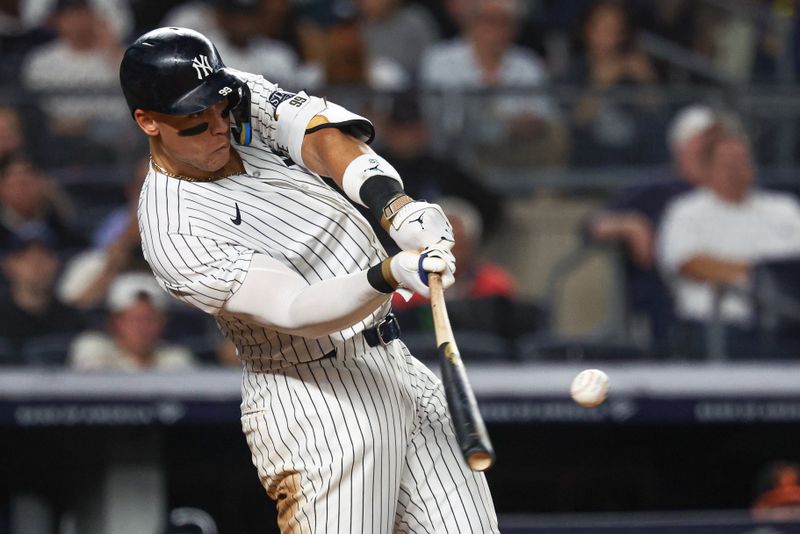 Sep 26, 2024; Bronx, New York, USA; New York Yankees center fielder Aaron Judge (99) hits a two run home run during the seventh inning against the Baltimore Orioles at Yankee Stadium. Mandatory Credit: Vincent Carchietta-Imagn Images