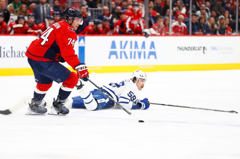 Mar 20, 2024; Washington, District of Columbia, USA; Washington Capitals defenseman John Carlson (74) reaches for the puck in front of Toronto Maple Leafs left wing Tyler Bertuzzi (59) during the third period at Capital One Arena. Mandatory Credit: Amber Searls-USA TODAY Sports