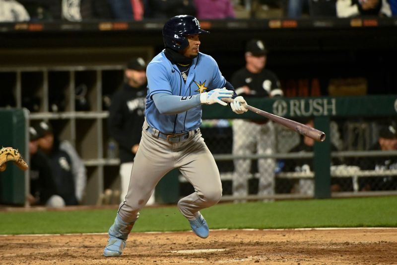 Apr 29, 2023; Chicago, Illinois, USA; Tampa Bay Rays shortstop Wander Franco (5) hits a two RBI single against the Chicago White Sox during the seventh inning at Guaranteed Rate Field. Mandatory Credit: Matt Marton-USA TODAY Sports