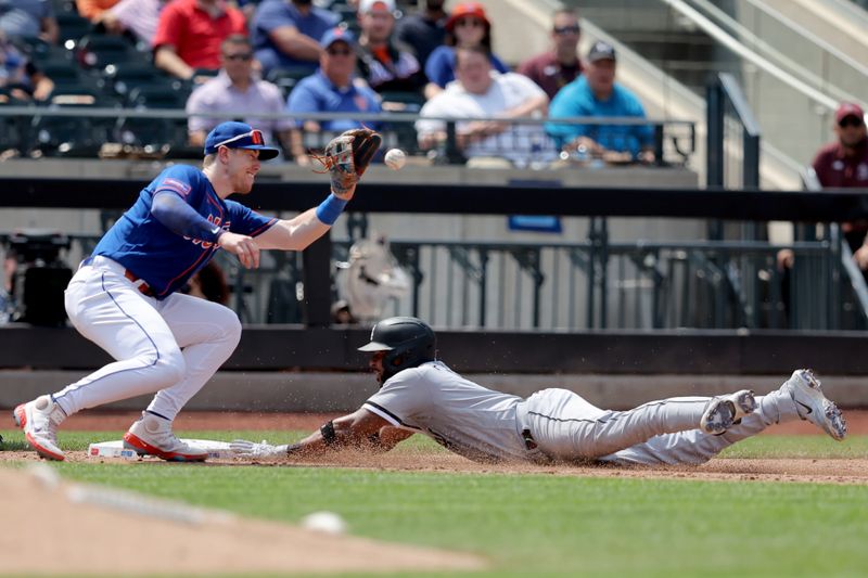 Jul 20, 2023; New York City, New York, USA; Chicago White Sox second baseman Elvis Andrus (1) slides into third base with an RBI triple ahead of a tag by New York Mets third baseman Brett Baty (22) during the sixth inning at Citi Field. Mandatory Credit: Brad Penner-USA TODAY Sports