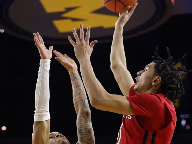 Feb 3, 2024; Ann Arbor, Michigan, USA;  Rutgers Scarlet Knights guard Derek Simpson (0) shoots on Michigan Wolverines guard Dug McDaniel (0) in the second half at Crisler Center. Mandatory Credit: Rick Osentoski-USA TODAY Sports